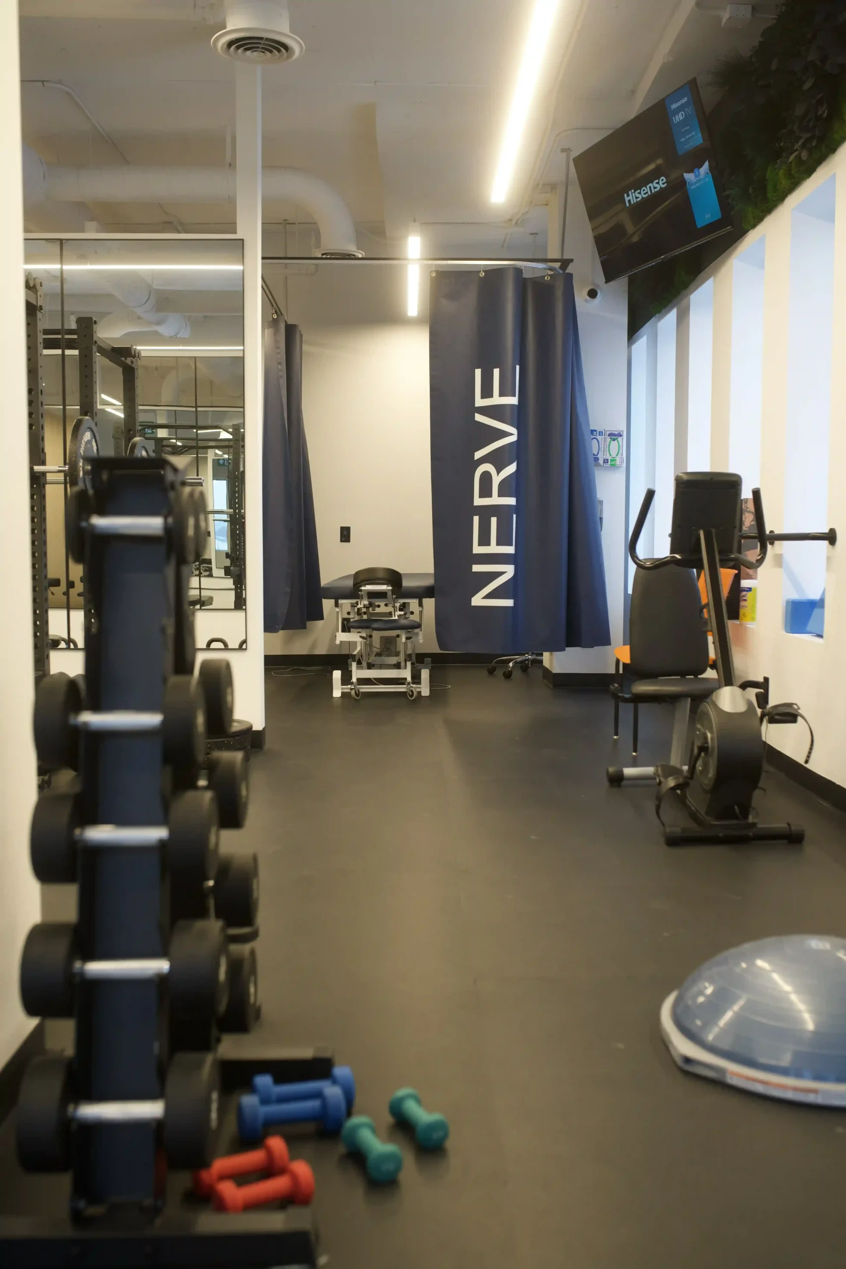 Physiotherapy clinic with gym equipment and treatment area