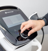 therapist adjusting shockwave machine